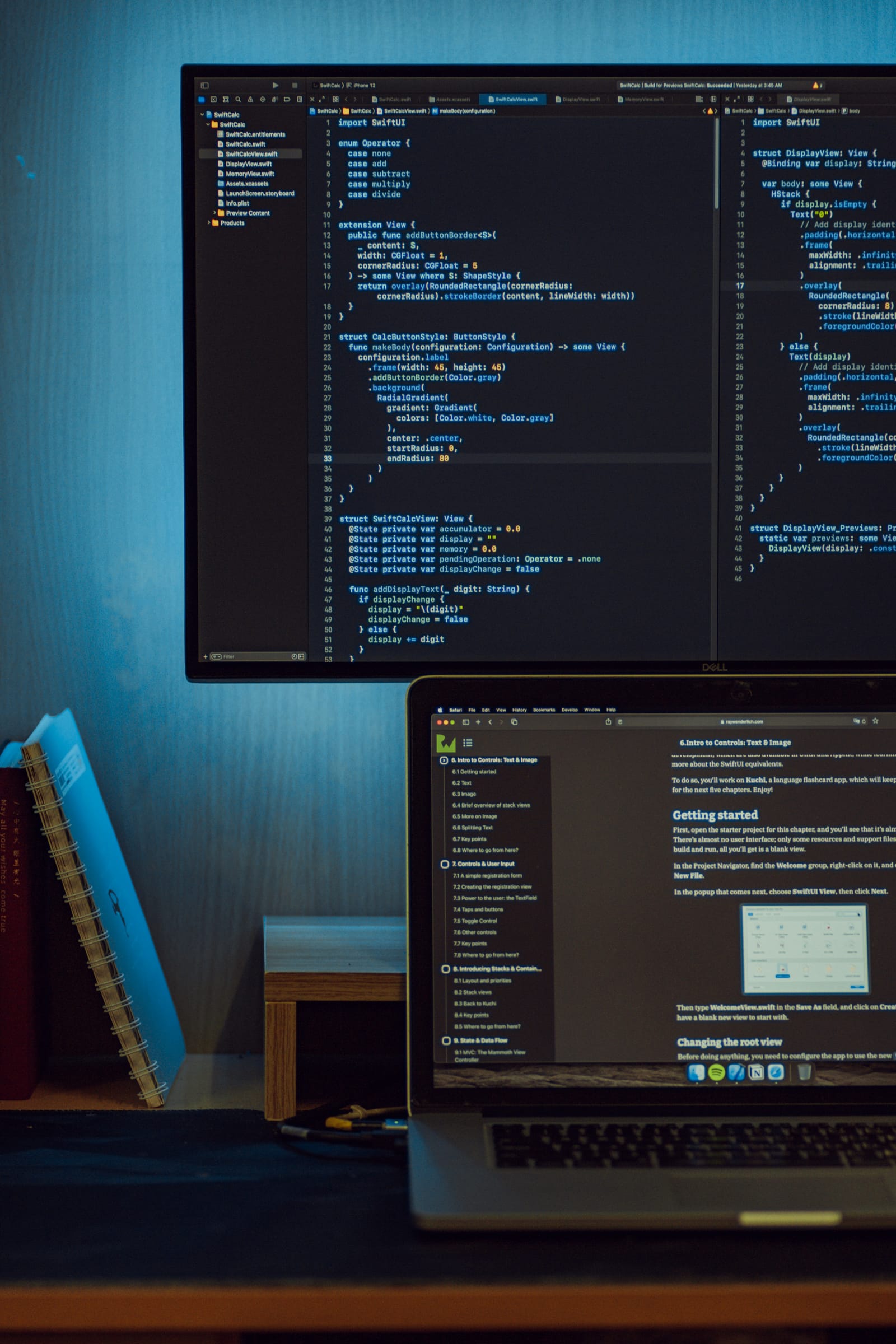 Developer working across multiple monitors of code